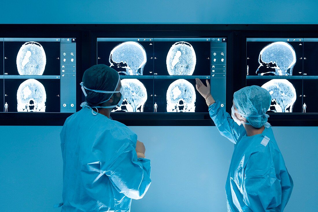 Surgeons looking at MRI scans during surgery