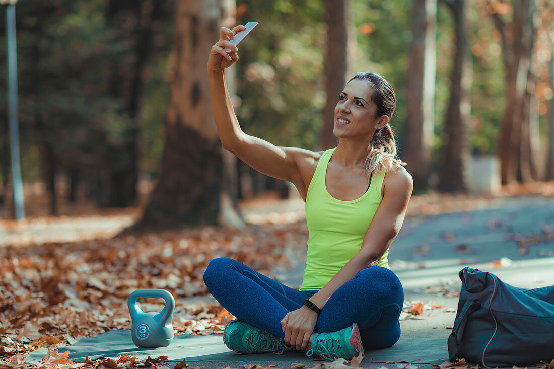 Woman taking selfie after training outdoors