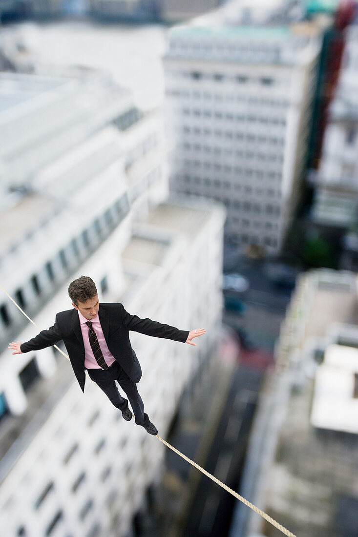 Businessman walking on a tightrope