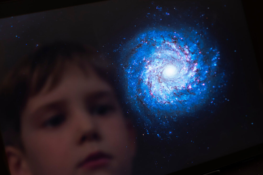 Boy looking at a galaxy