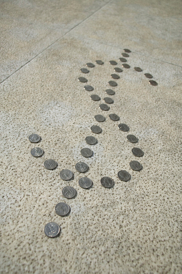 Quarter dollar coins in the shape of the dollar sign