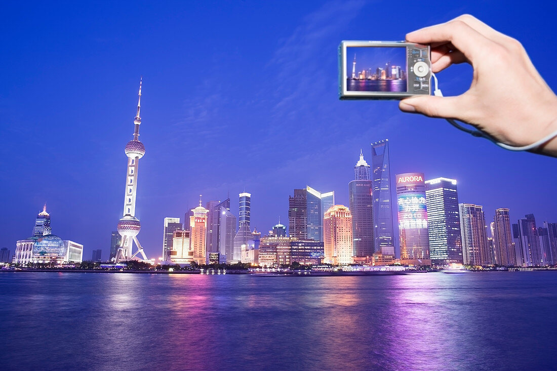 Tourist photographing Shanghai skyline, China