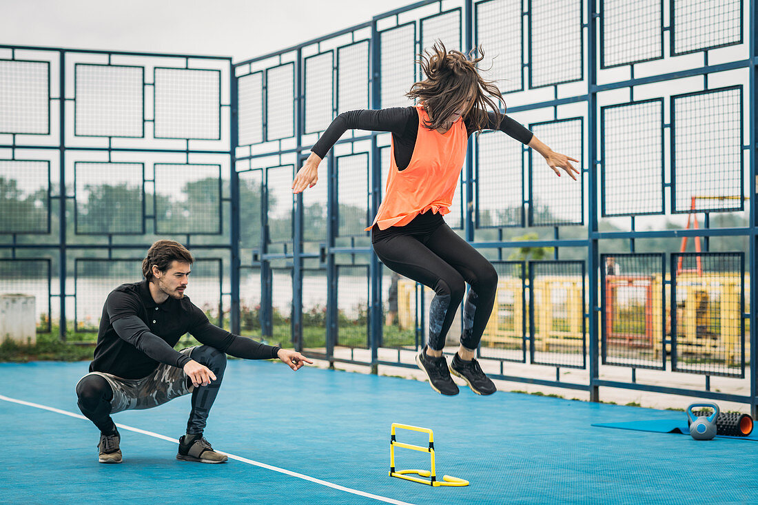 Hurdle training with personal trainer