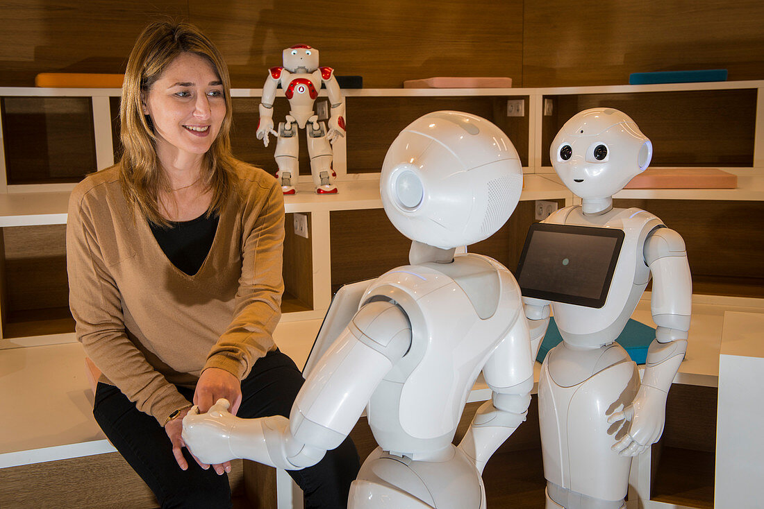 Researcher with Pepper and Nao robots