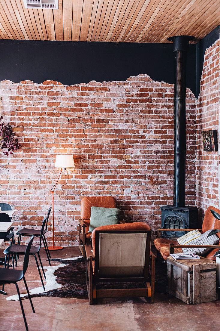 Rustic living room with brick wall and stove