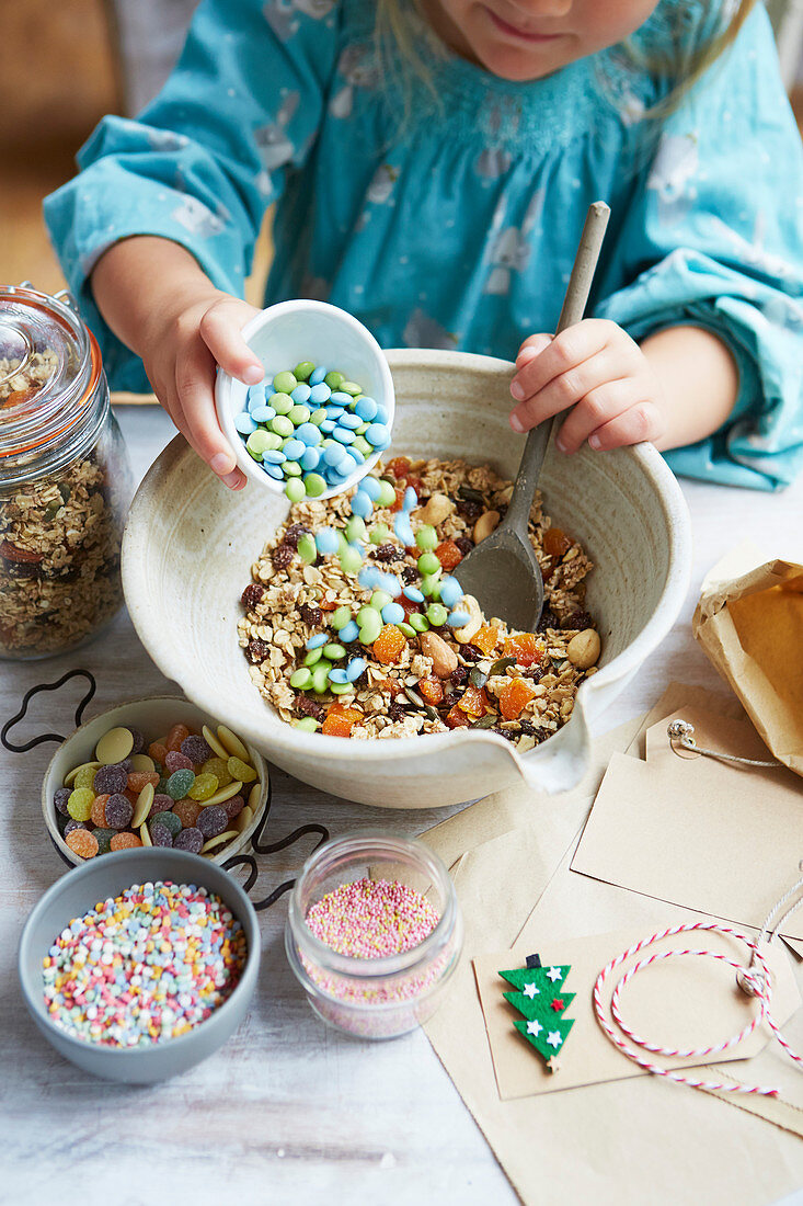 Kid mixing 'reindeer food' with seeds, oats and sweets