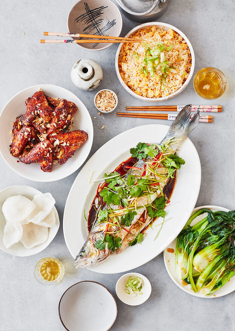 Chinese steamed sea bass, asian greens and sichuan chicken wings