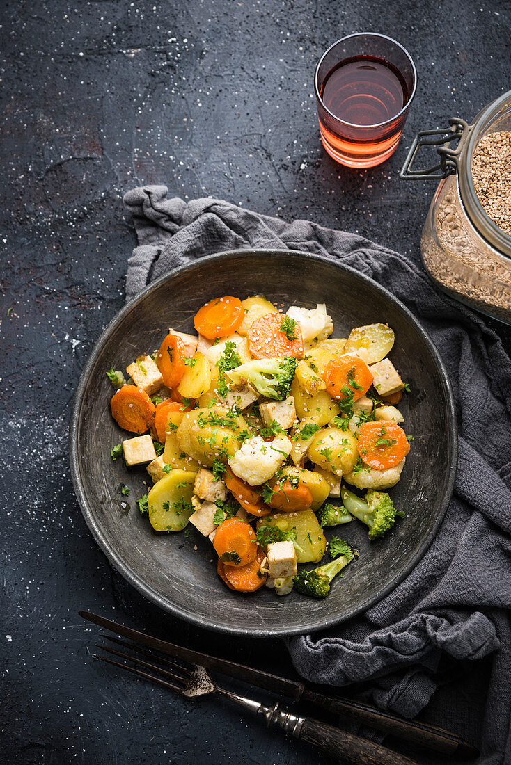 Vegan potato and vegetable medley with tofu and sesame seeds