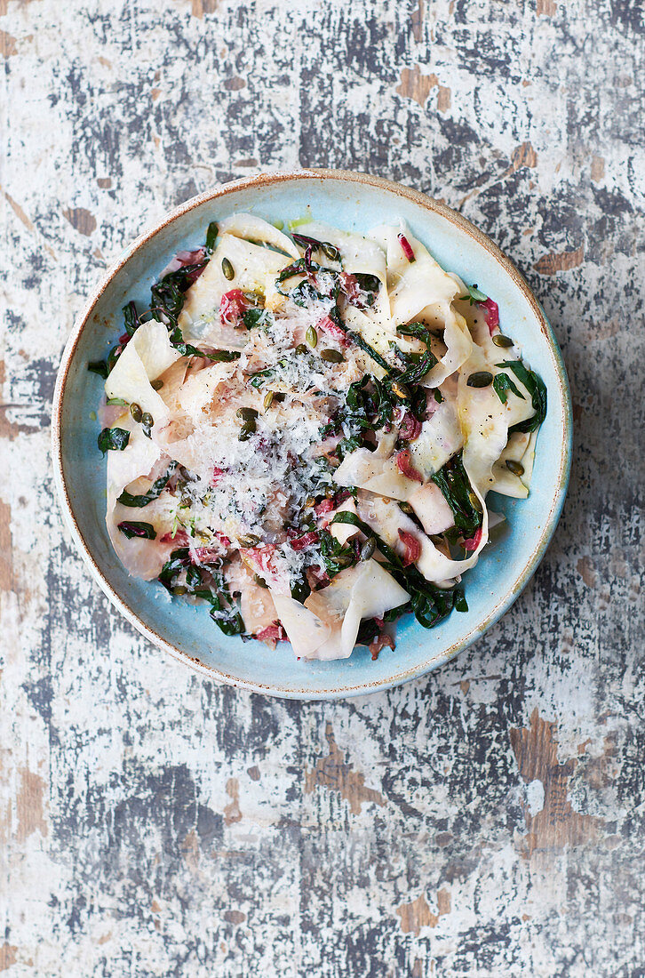 Celeriac ribbon 'pasta' tossed with chard, garlic and pumpkin seeds