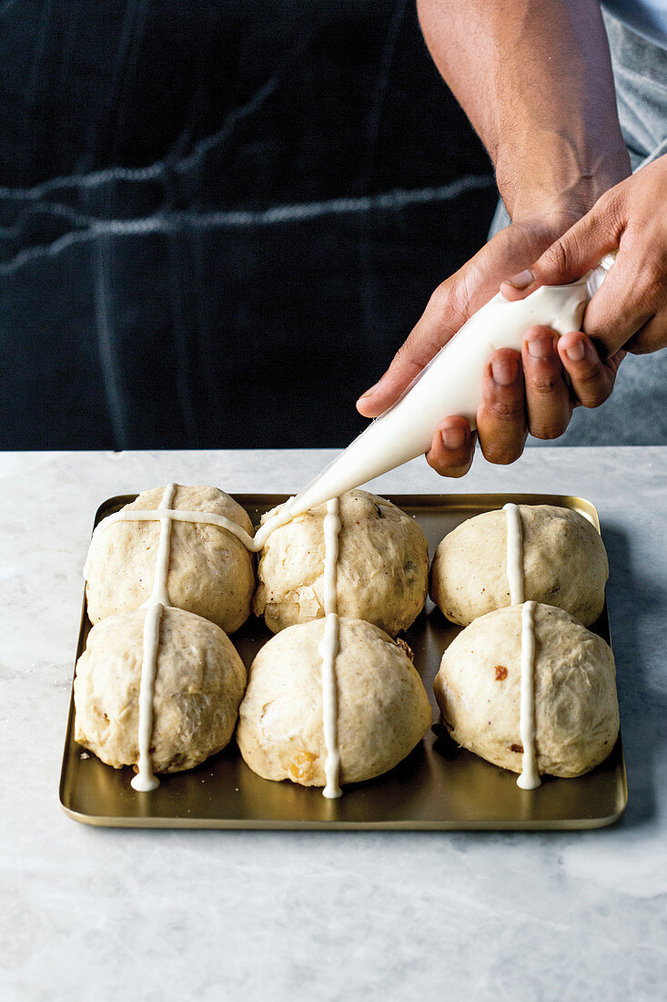 Preparing hraditional hot cross buns