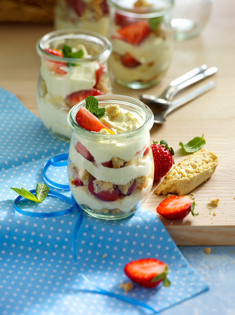 Layered desserts in glasses with strawberries and orange mascarpone