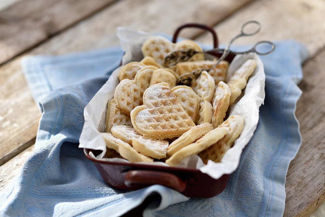 Vegan buttermilk waffles in a baking tin with tongs