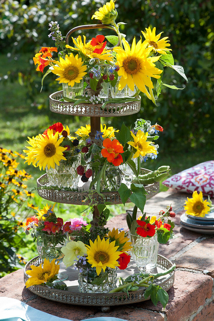 Metal tray with small bouquets of sunflowers, nasturtiums, blackberries, borage, snapdragons and beans