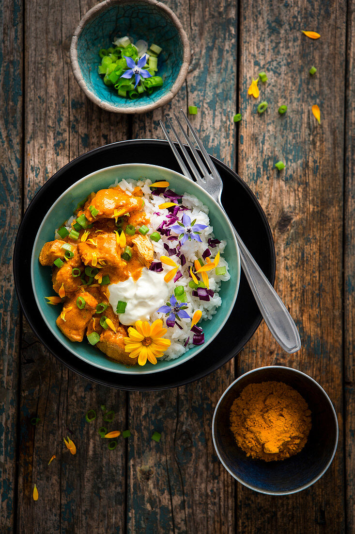 Butter chicken with yoghurt and edible flowers