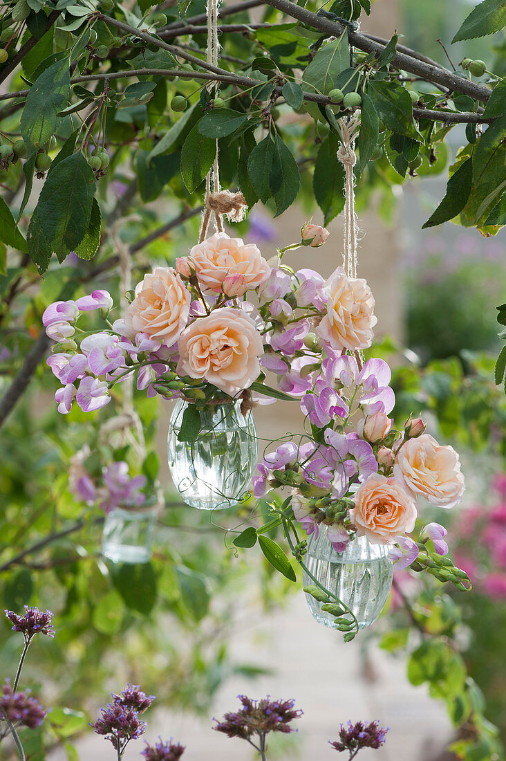 Hanging bouquets of roses and sweet peas
