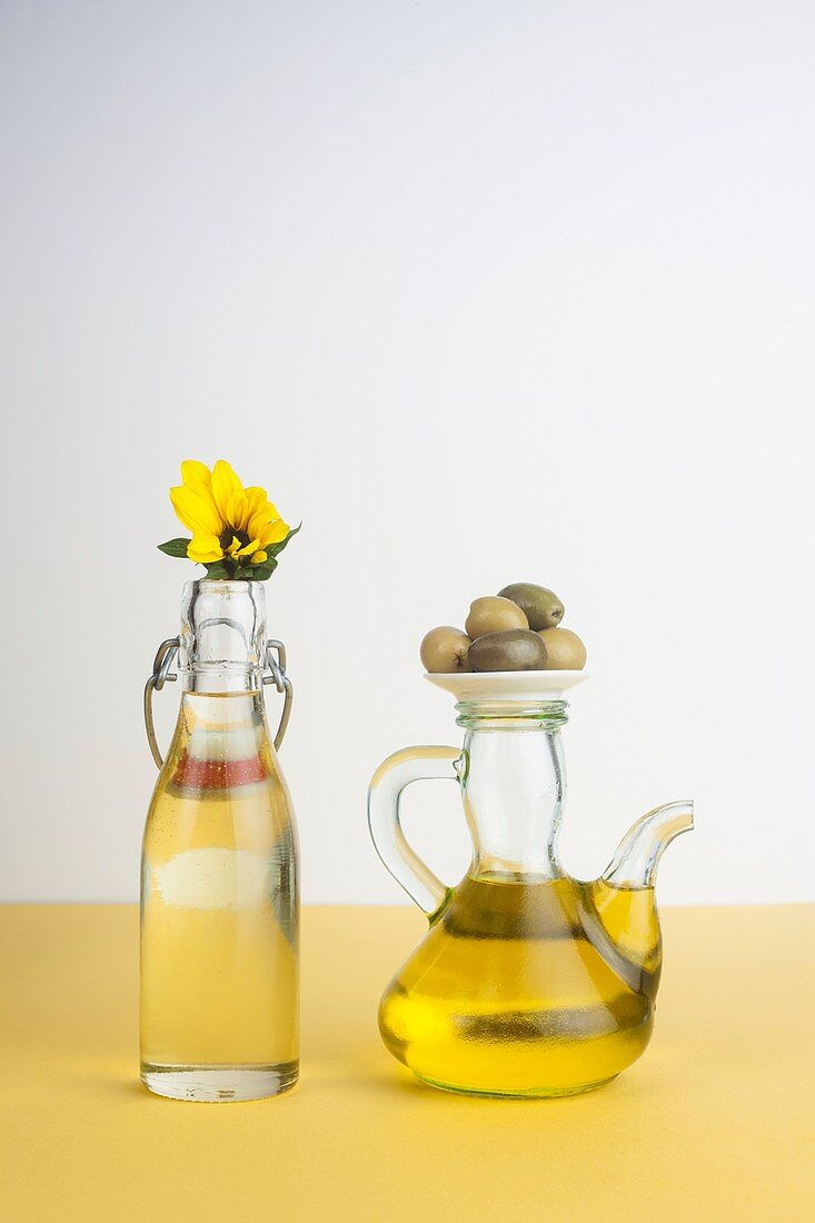 Bottle of sunflower oil and jug of olive oil