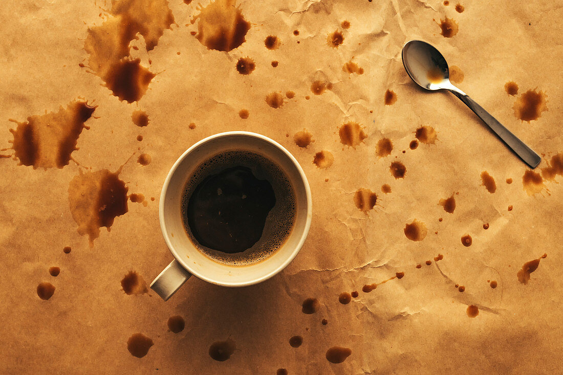 Coffee cup and spoon with splashes