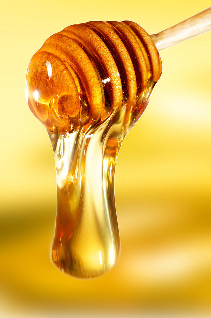 Honey on wooden dipper