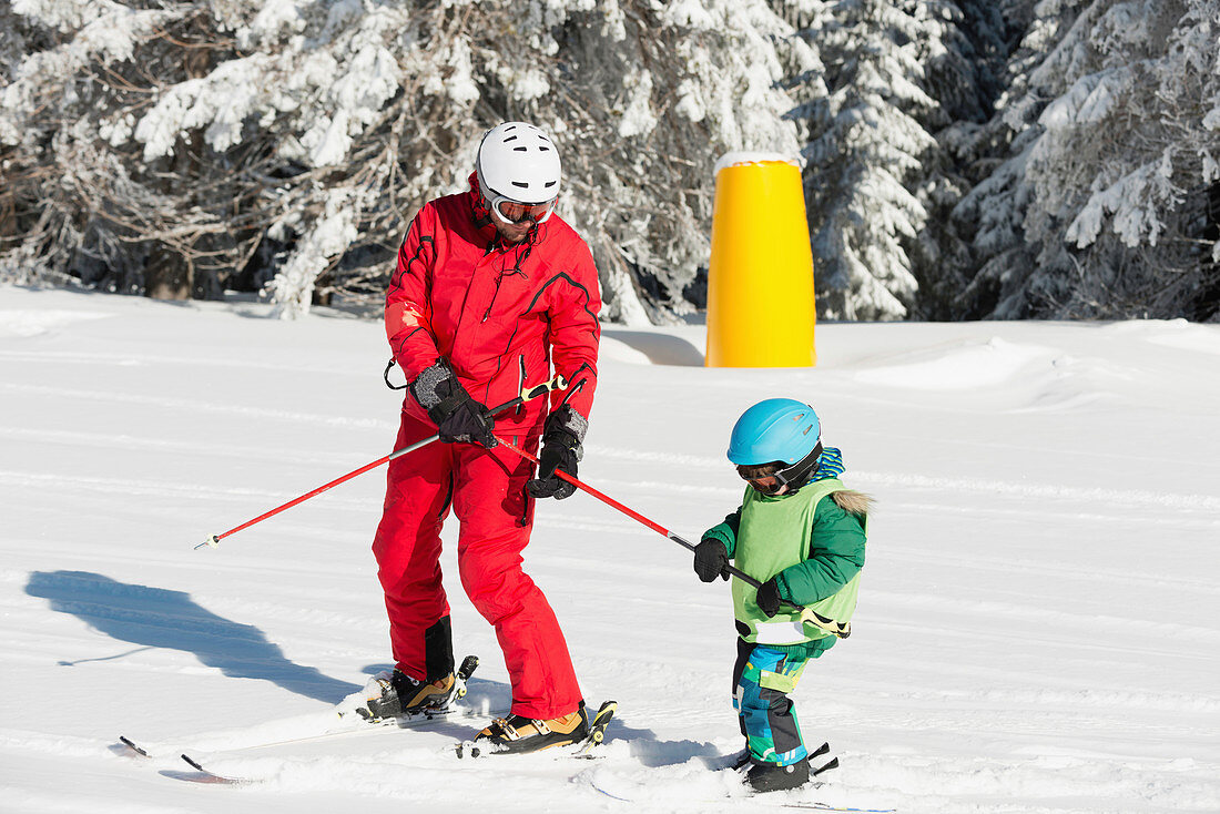Boy having skiing lesson