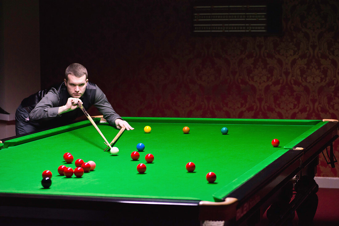 Snooker player taking a shot