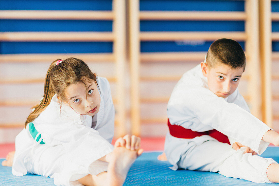 Children stretching in taekwondo class