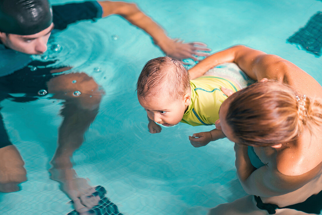 Baby boy and mother in swimming pool