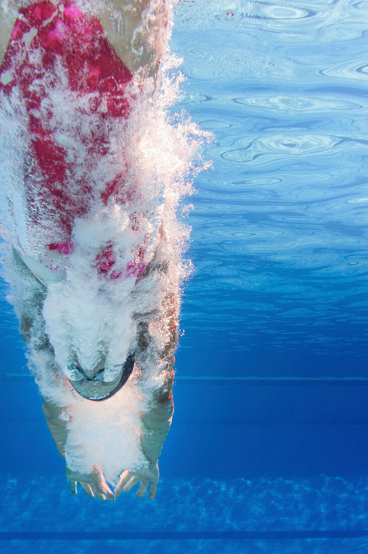 Swimmer diving into pool