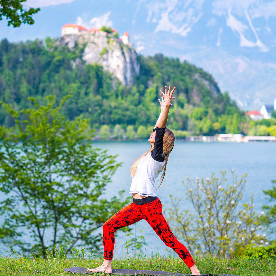 Woman doing yoga by a lake