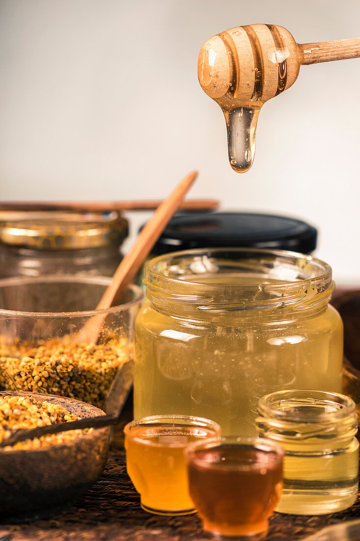 Honey flowing into a glass jar