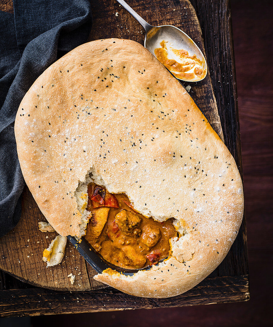 Butter chicken pie with naan crust