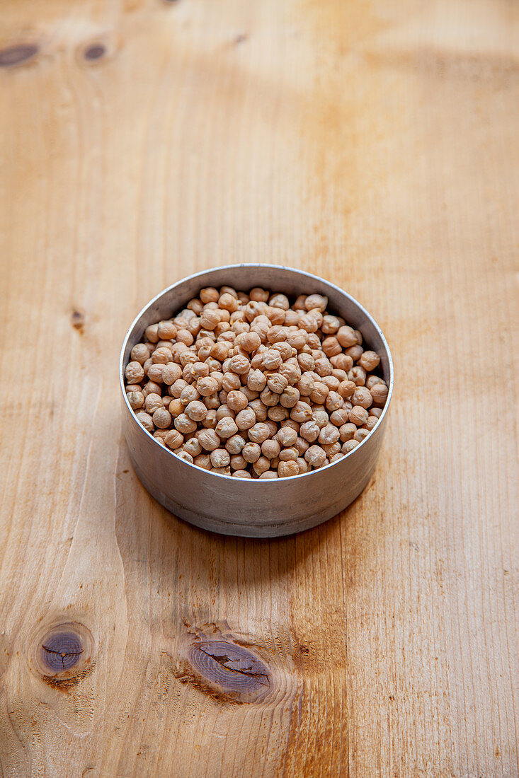Dried chickpeas in a metal tin