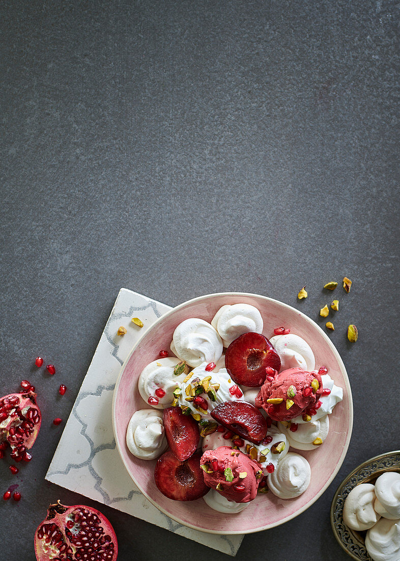 Vegan meringues with berry sorbet and plums