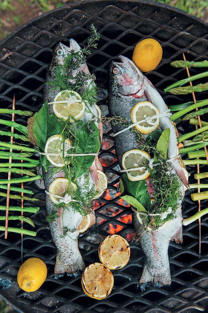 Trout with butter, lemon and herbs on a grill