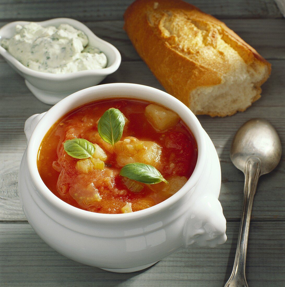 Tomato soup with vegetables, baguette & herb quark in bowl