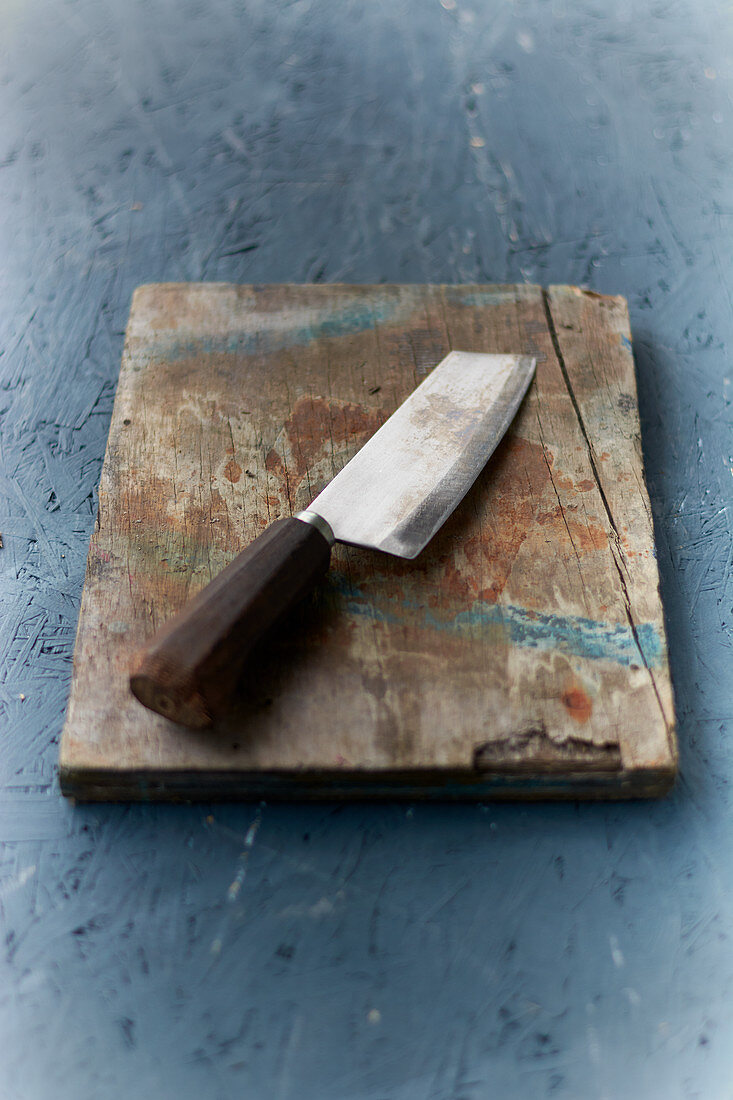 A chef's knife on a wooden board