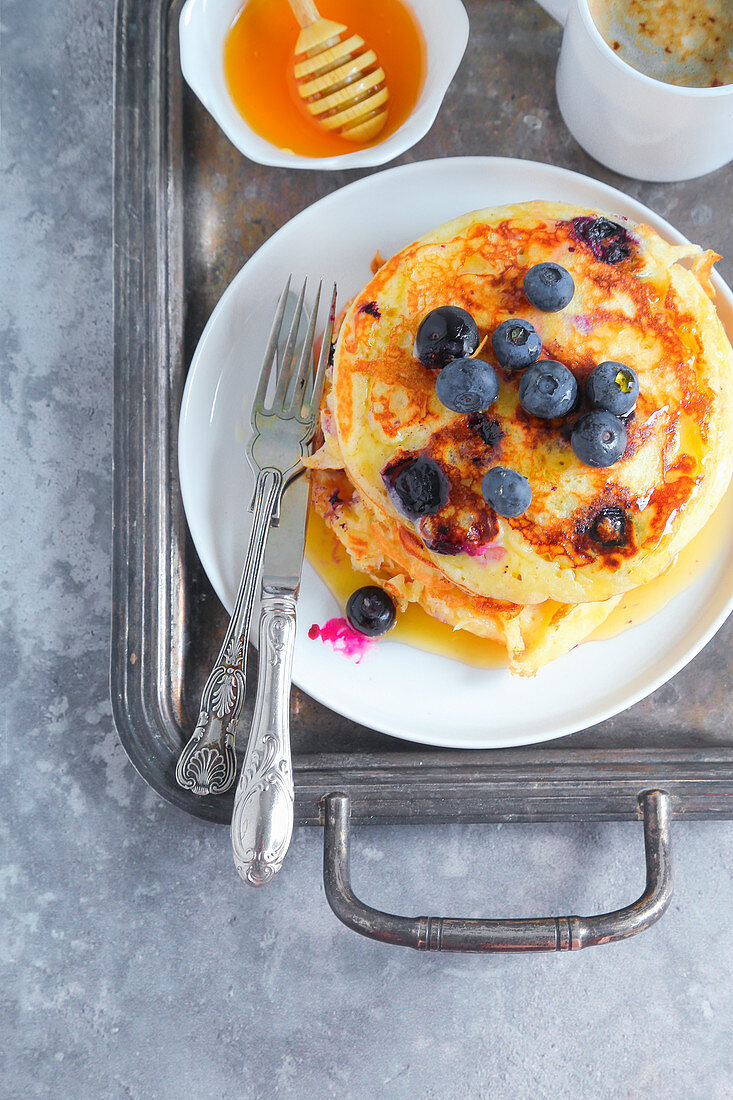 Blueberry pancakes served with honey and barley coffee