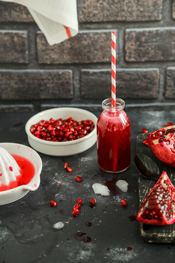 Pomegranate juice with grains and juicer