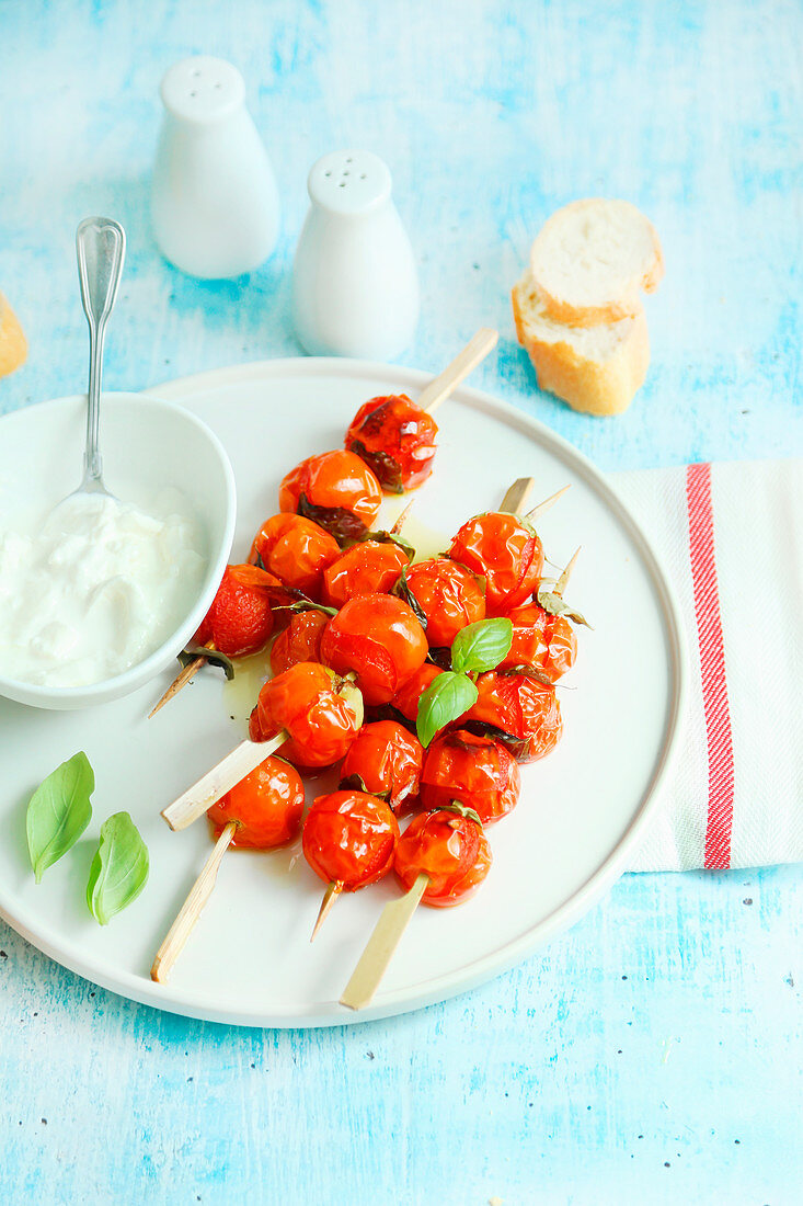 Roasted cherry tomato skewers served with fresh stracciatella