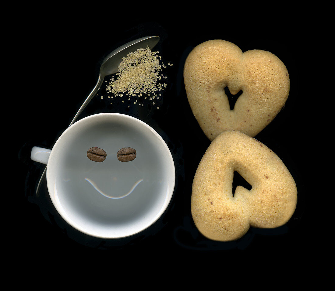 Laughing coffee cup with heart cookies