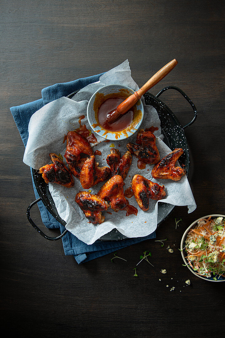 Chicken wings with homemade bbq sauce, celeriac and blue cheese slaw