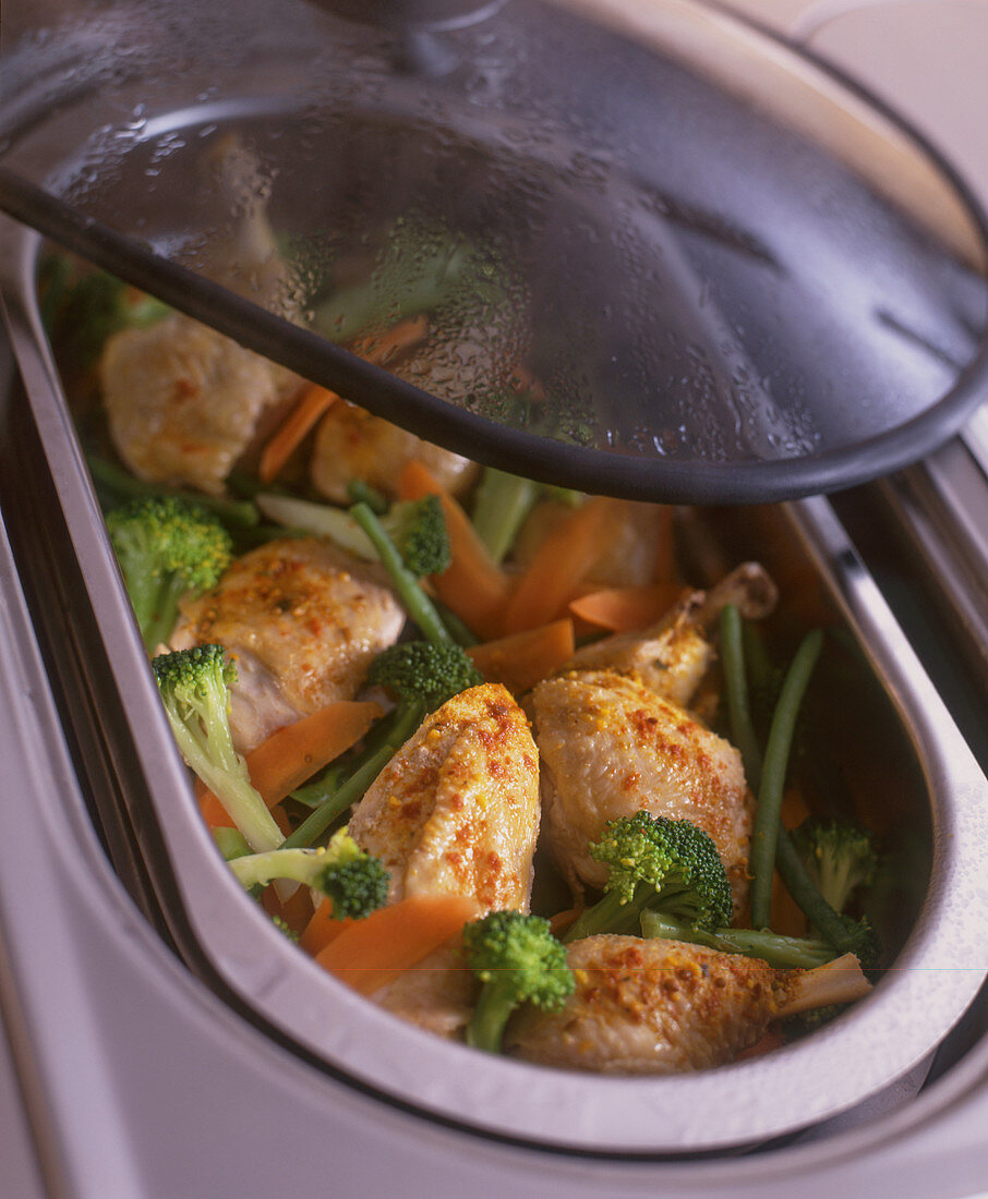 Chicken with vegetables in a steamer