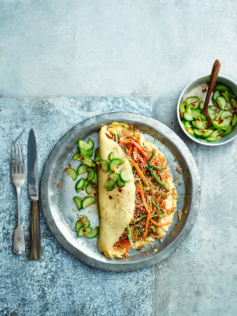 Rice-stuffed omelette with pickled cucumber