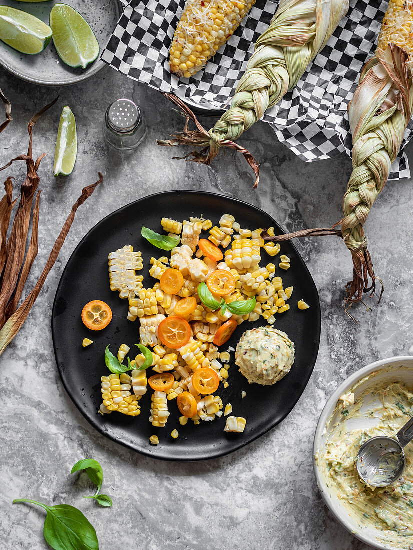 Shaved mexican street corn with herbed butter scoop on the plate.