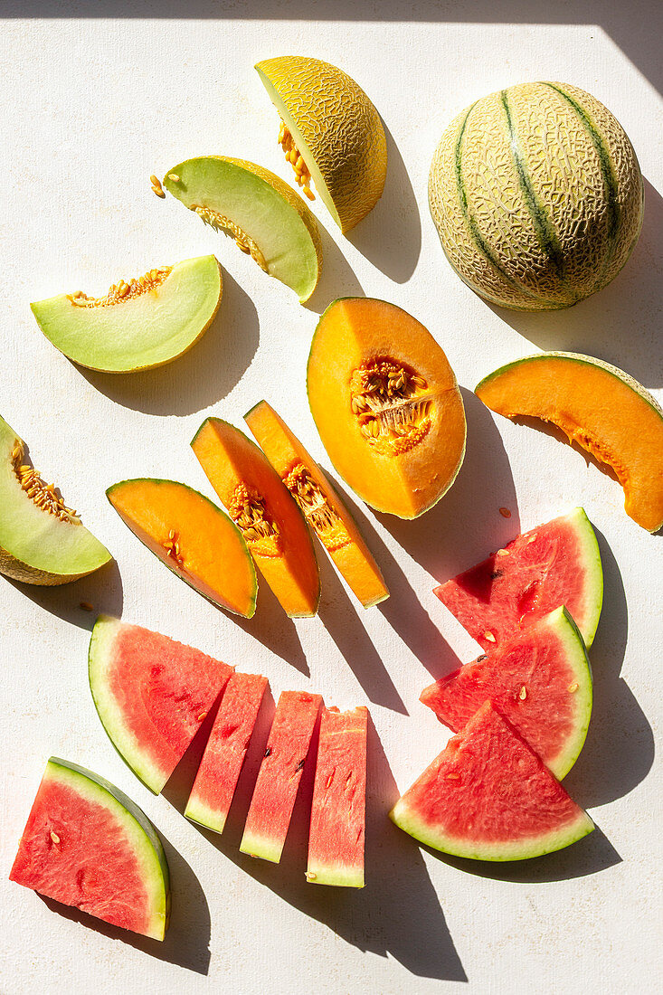 Slices of watermelon, cantaloupe and honeydew melon on the table