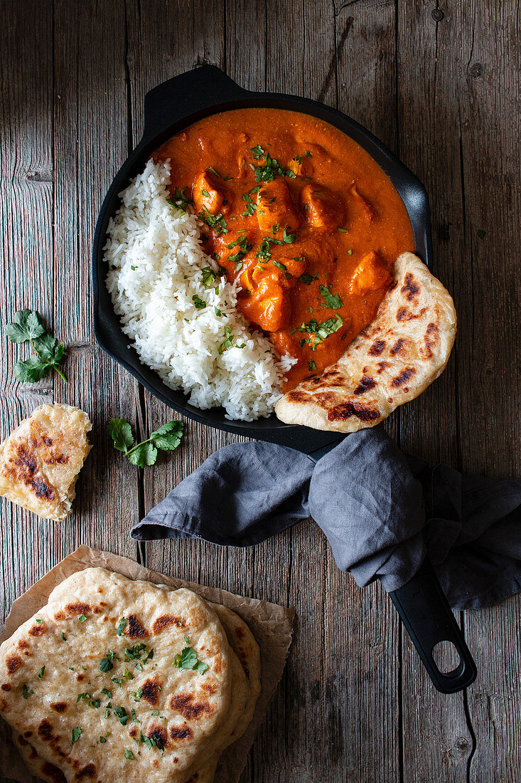 Close up of skillet full of delicious butter chicken and rice