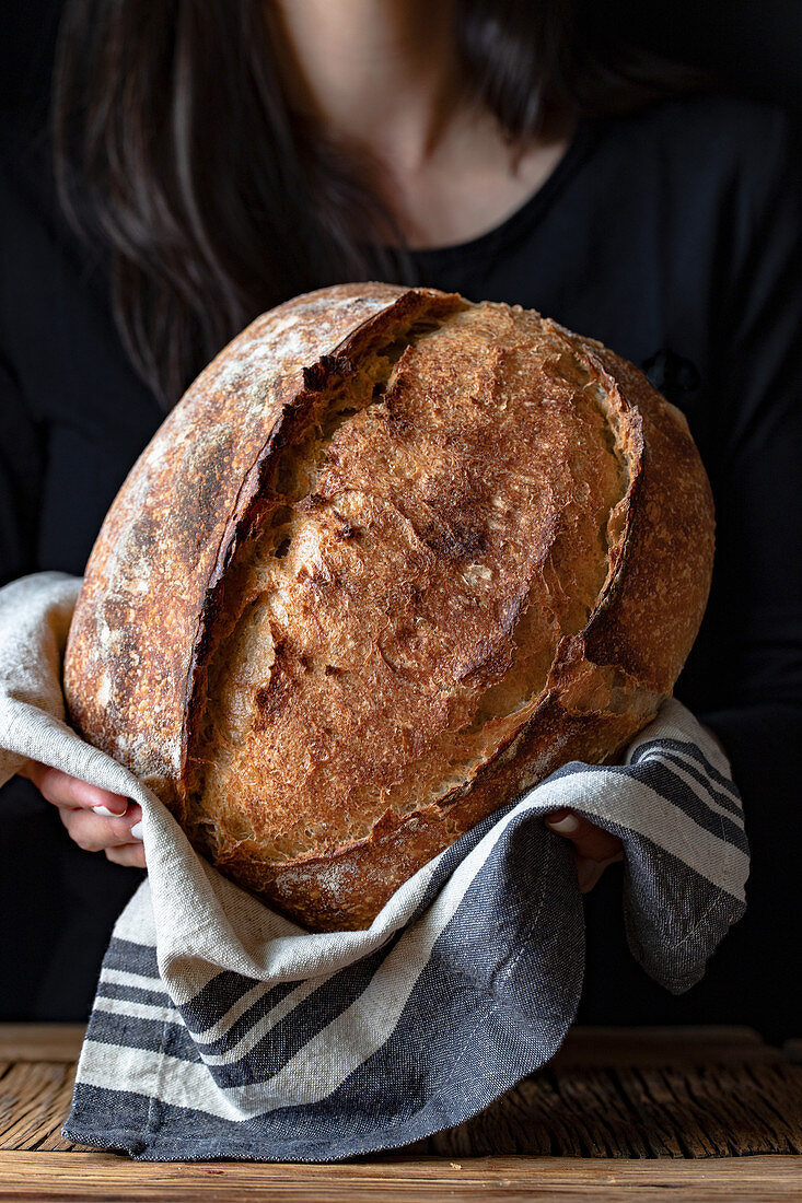 Unrecognizable person showing fresh bread