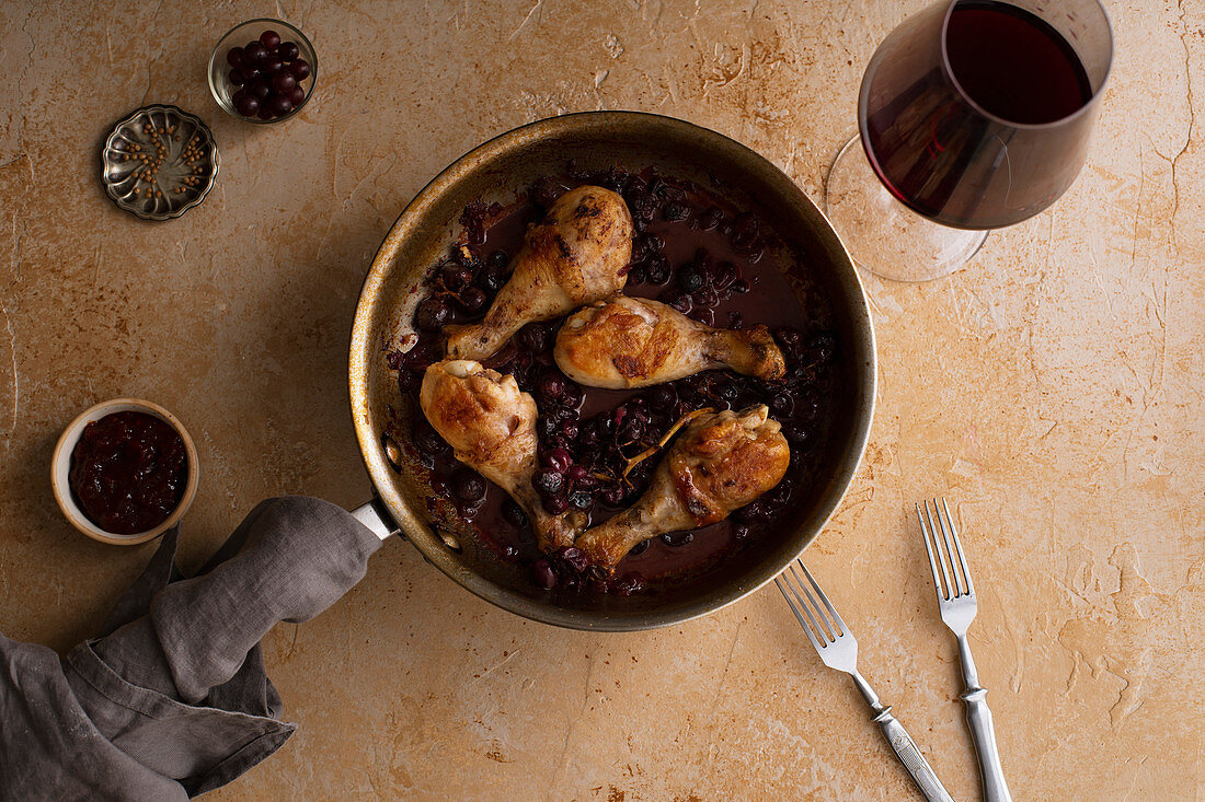 Roasted chicken with grapes and coriander in a pan