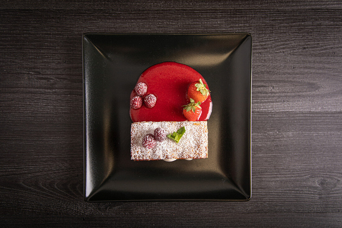 Diphlomate cream and red fruit strudel in elegant black plate
