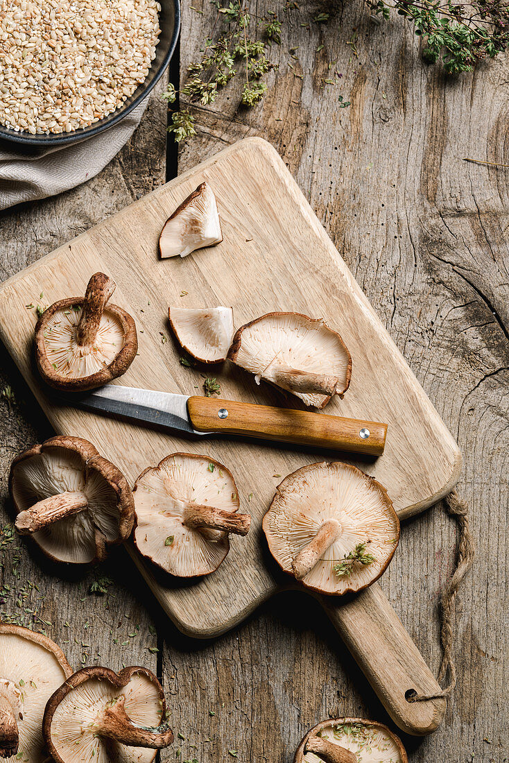 Pile of fresh brown mushrooms on rustic wooden table