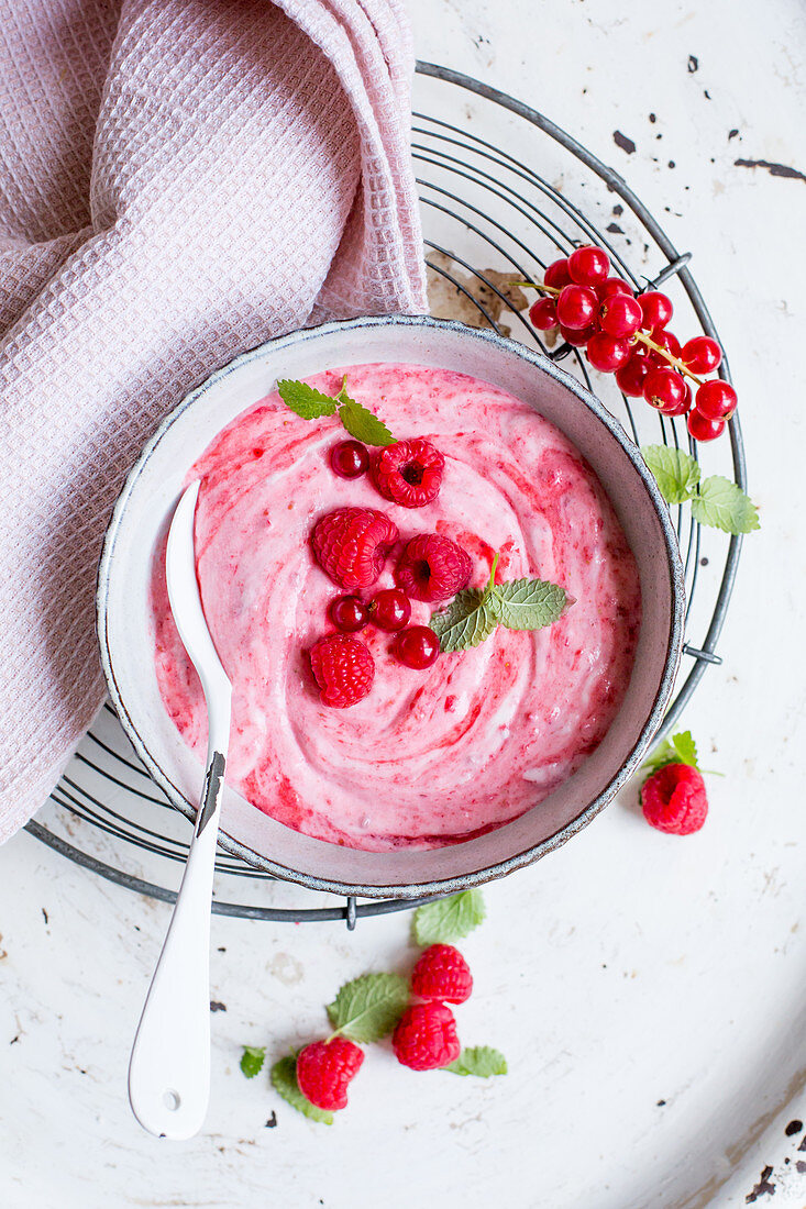 A creamy dessert with raspberries and redcurrants